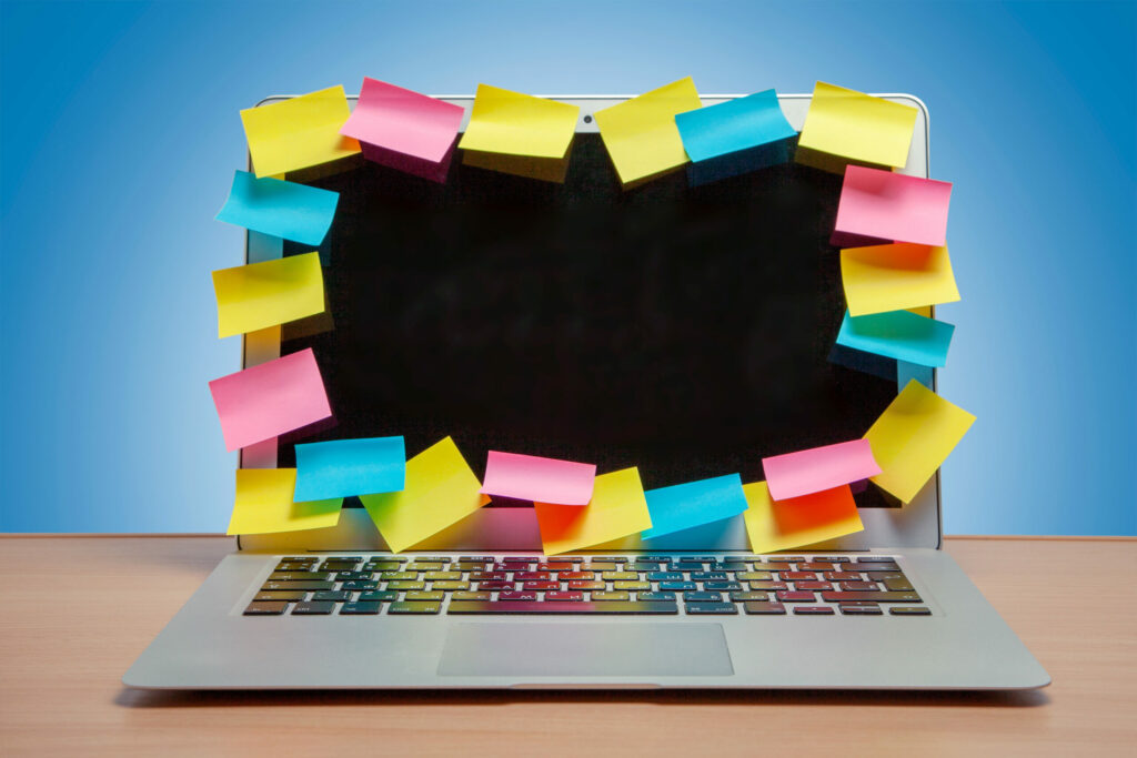 Laptop covered in sticky notes to show what life as an entrepreneur with adhd might look like
